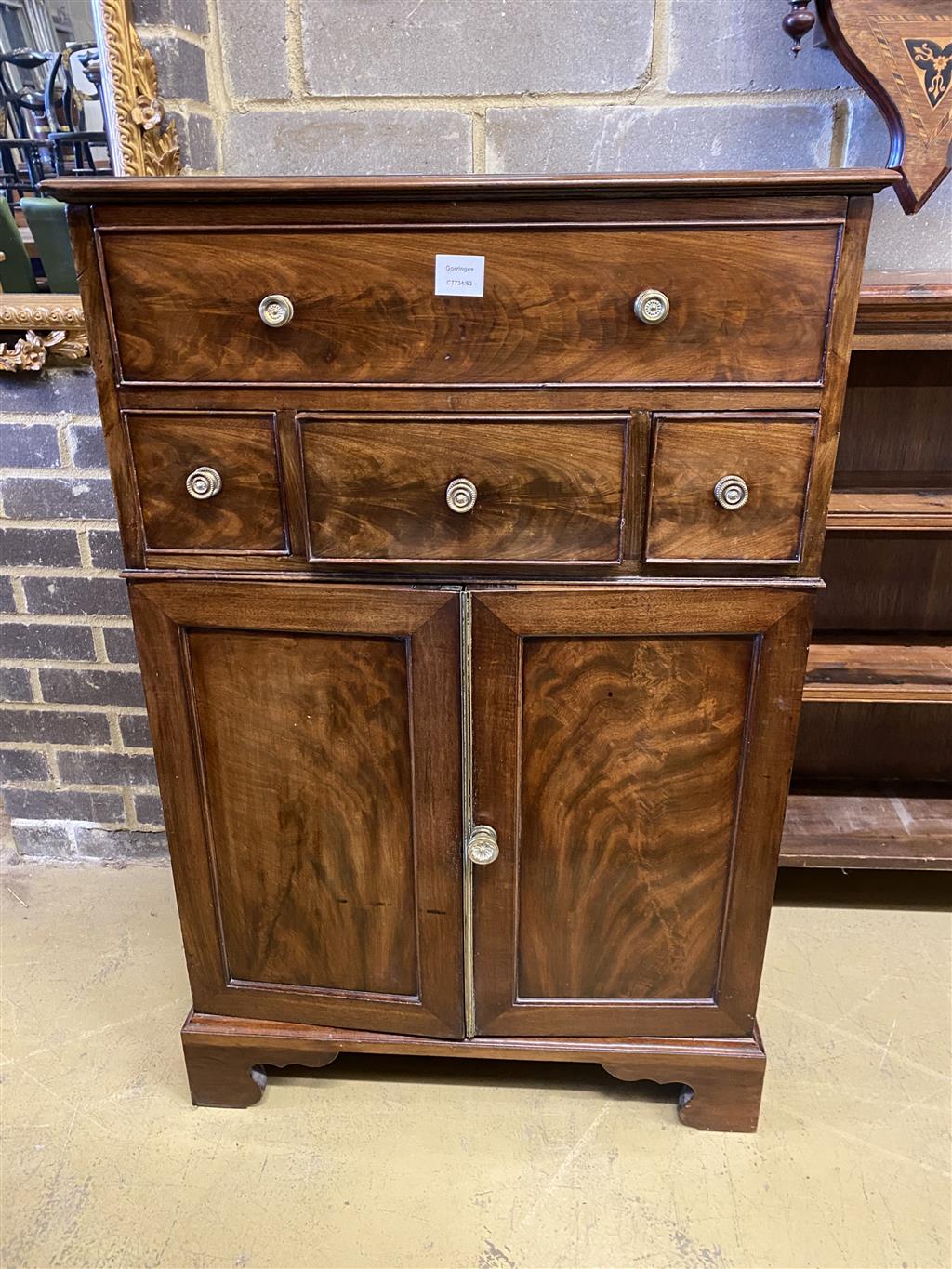 A Regency mahogany cupboard, fitted four drawers over a pair of fielded panelled doors (altered), width 69cm, depth 56cm, height 104cm